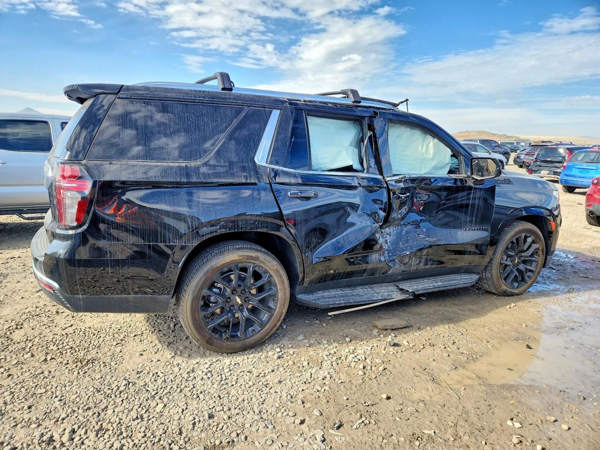 Black SUV with passenger-side door and fender collision damage