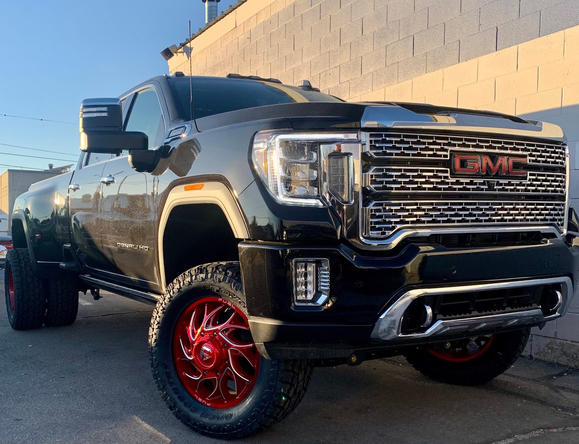 Black GMC Denali HD with red wheels